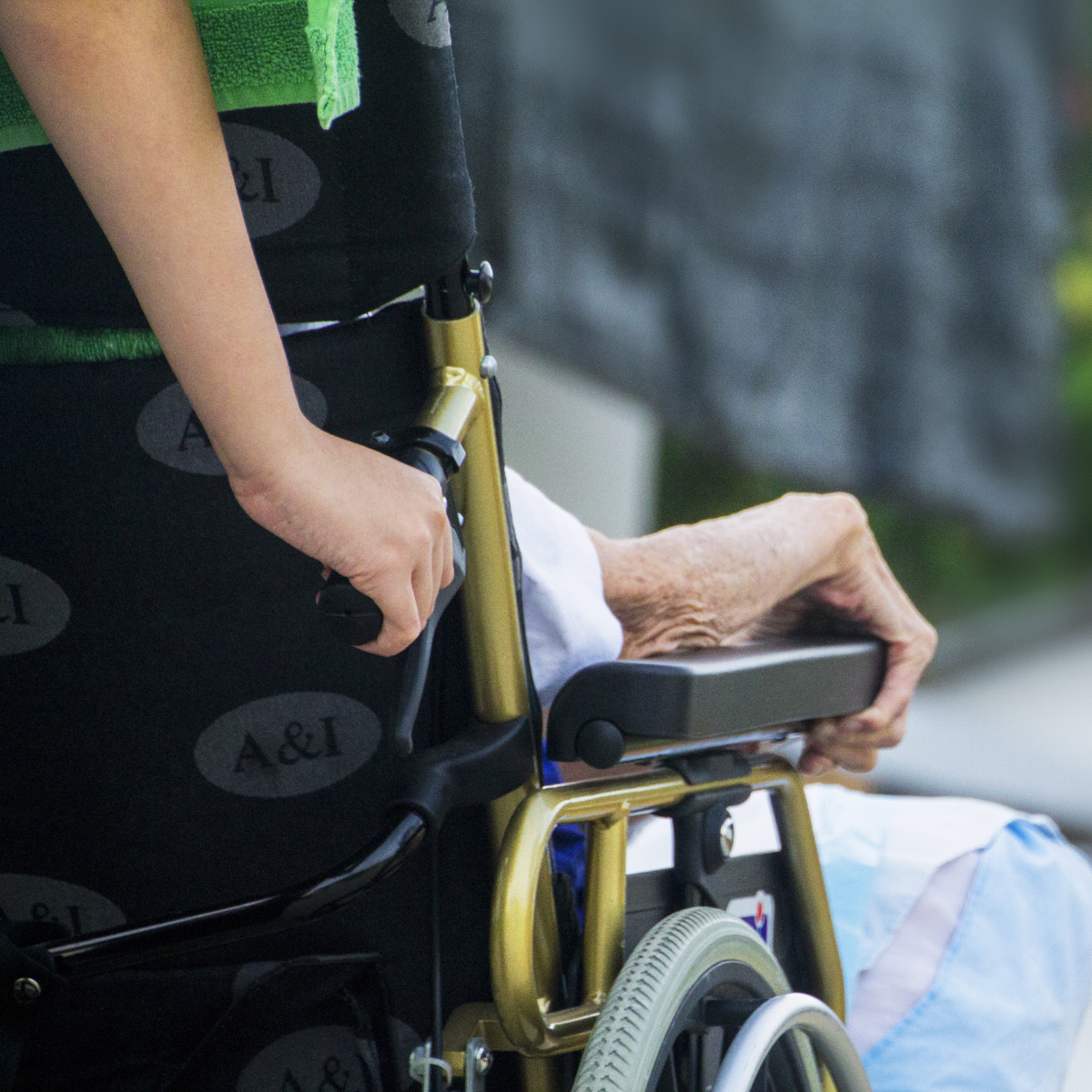 Old woman being pushed in a wheelchair to show elder neglect and abuse in assisted living and nursing homes