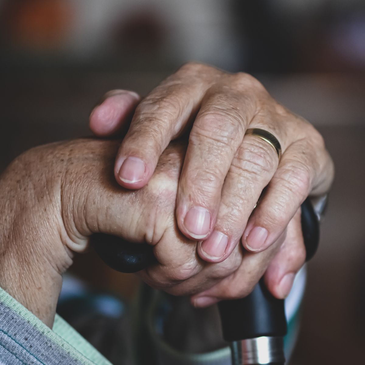 Picture of an elderly person’s folded hands, illustrating an elder abuse and neglect lawsuit after a resident died from hypothermia outdoors.
